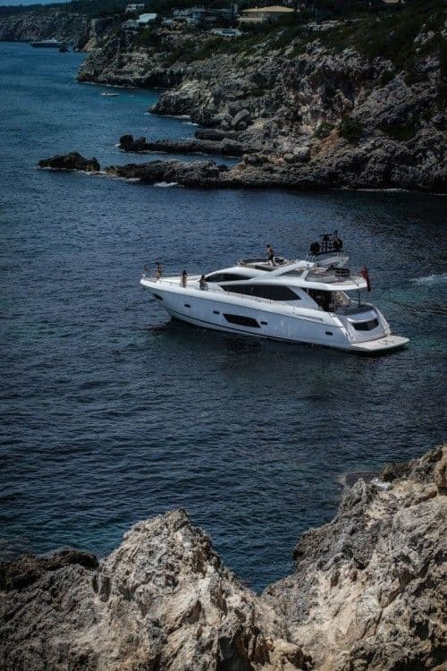 White motor yacht in a secluded Albanian cove