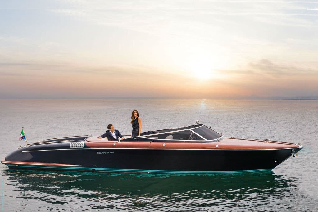 Riva-style luxury speedboat on sunset water