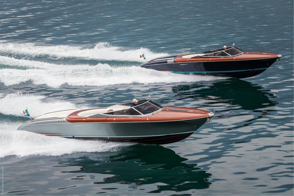 Three luxury speedboats in formation at speed