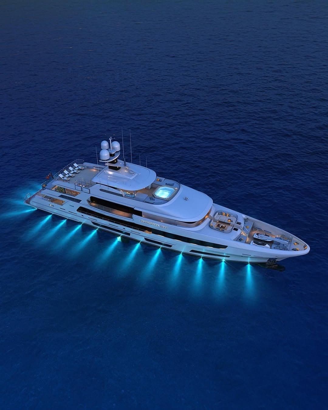 Superyacht with underwater lights at night